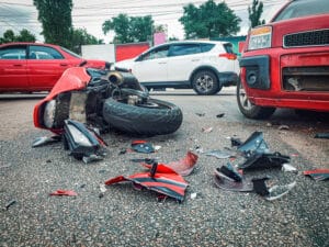 Car accident that involves multiple different vehicles, including cars and a motorcycle